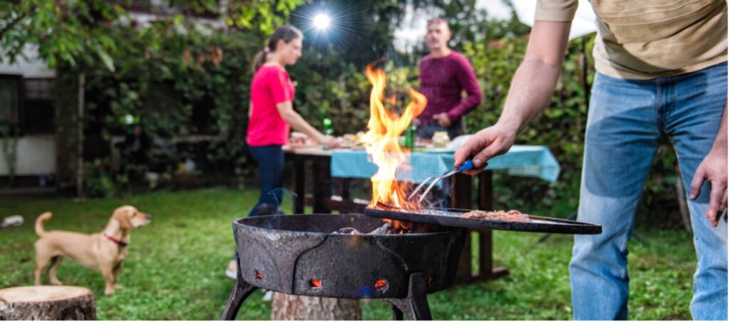 A picture containing dog, outdoor, barbecue, person